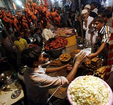 Muslims buy food from a roadside stall in the old quarters of Mumbai