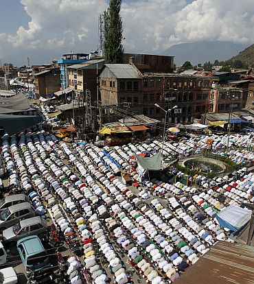 Kashmiri Muslim men attend prayers outside Jamia Masjid in Srinagar