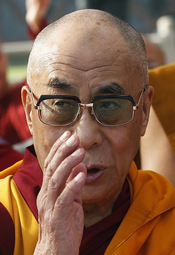 Tibetan spiritual leader the Dalai Lama prays during an all faith prayer meet