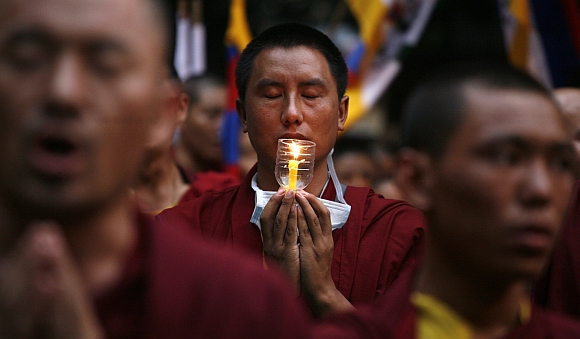 Tibetan monks pray during the congregation