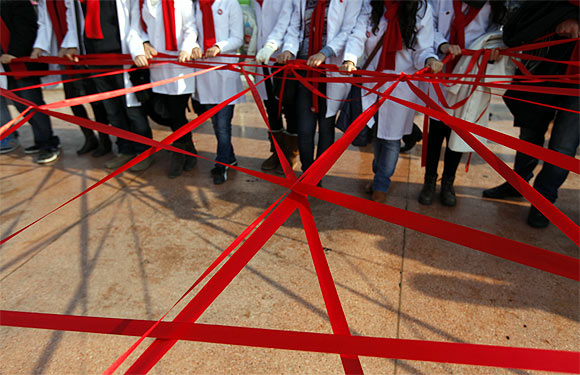 Medical students form a red ribbon, the symbol of the worldwide campaign against AIDS, during an HIV/AIDS awareness rally on World AIDS Day in central Istanbul