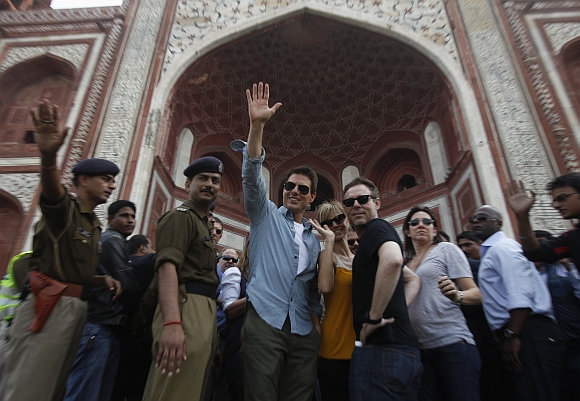 Cruise waves towards his fans as he arrives at the Taj Mahal