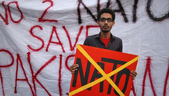 A student holds a placard during an anti-American demonstration near the U.S. consulate in Karachi