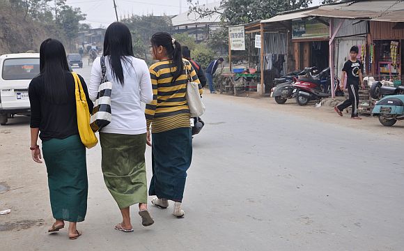 Young girls going for classes wear the phanek, the Manipuri sarong. Following bans by various groups, schools and colleges made it mandatory for girls to wear the phanek