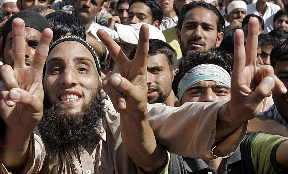 Kashmiri protesters gesture during a sit-in demonstration in Srinagar