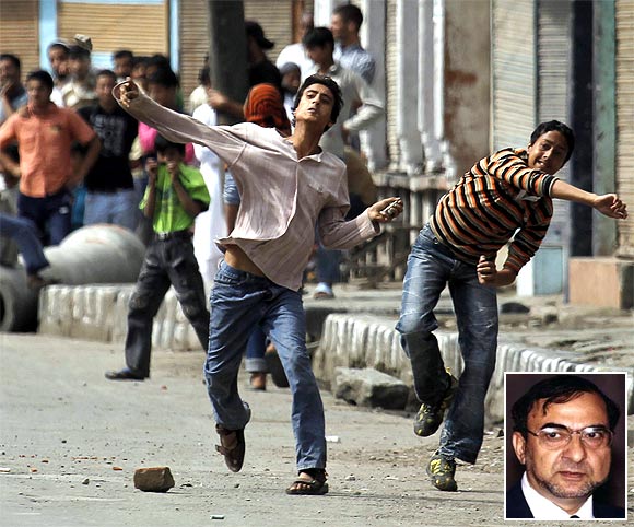 Kashmiri protesters throw stones towards policemen during an agitation. Inset: Syed Ghulam Nabi Fai