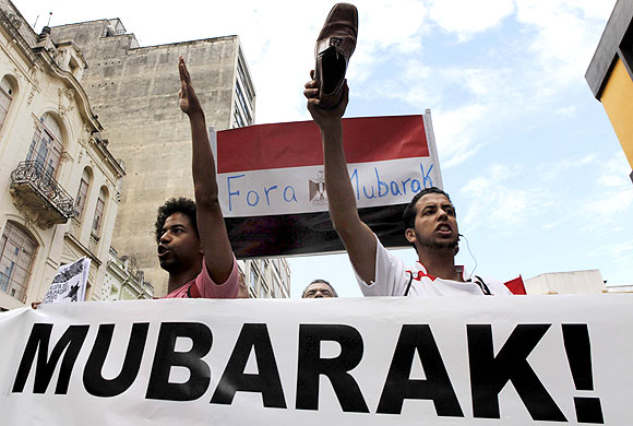 An Arab demonstrator holds a shoe as he shouts slogans against Egypt's Hosni Mubarak