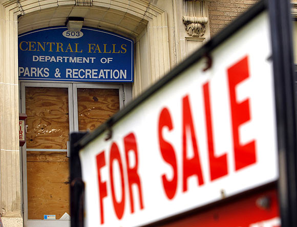 A 'For Sale' sign is seen outside the boarded up entrance to the Central Falls Department of Parks and Recreation in Central Falls, Rhode Island August 1.  Central Falls, one of a handful of US cities and counties facing fiscal collapse in the wake of the economic recession, filed for a rare Chapter 9 bankruptcy