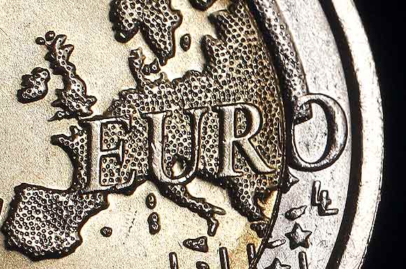 The map of Europe is featured on the face of a two Euro coin seen in this photo illustration taken in Rome, December 3. Standard & Poor's has warned it may carry out an unprecedented mass downgrade of euro zone countries, including Germany and France, if EU leaders fail to deliver a convincing agreement on how to solve the region's debt crisis