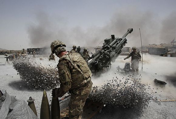 US Army soldiers from the 2nd Platoon, B battery 2-8 field artillery, fire a howitzer artillery piece at Seprwan Ghar forward fire base in Panjwai district, Kandahar province southern Afghanistan, June 12, 2011
