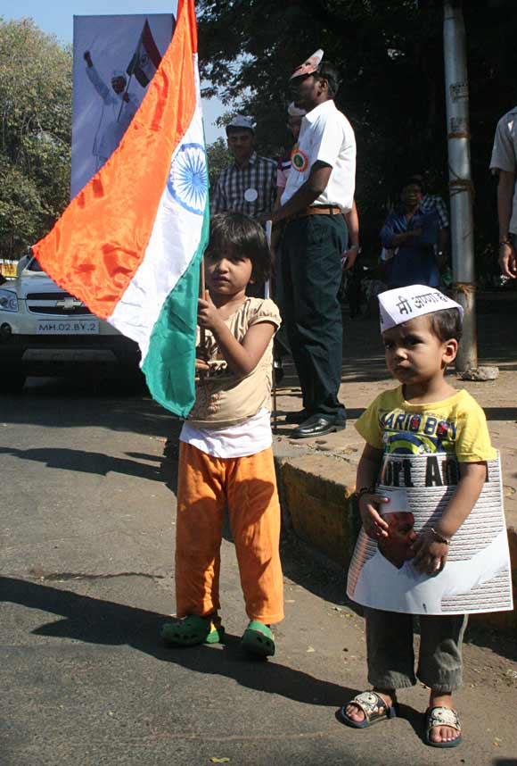 A girl holding the national flag and a boy sporting the Gandhian cap in Mumbai