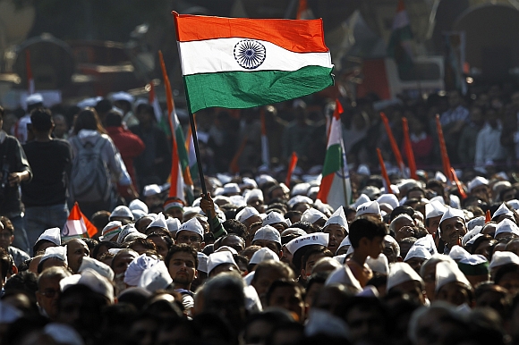A supporter of Hazare holds the India flag during Hazare's day-long hunger strike in New Delhi