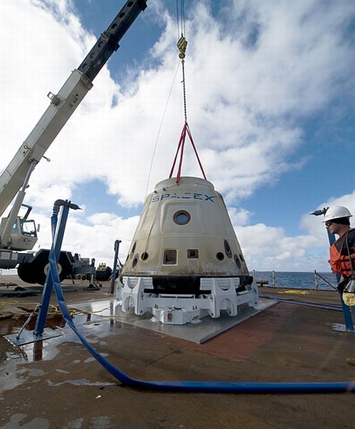 During test: The SpaceX crew brings the Dragon back to the barge where the crane lifted it from the water