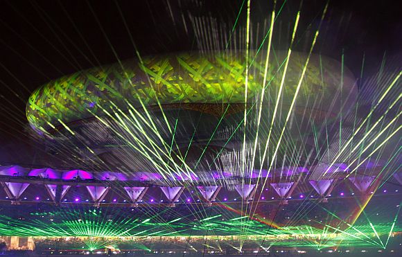 The Jawaharlal Nehru stadium is illuminated by lasers during the Commonwealth Games closing ceremony in New Delhi