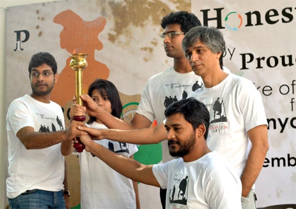 Members of 'Proud Indians' with the 'Flame of Honesty' that they will be carrying during their walkathon.