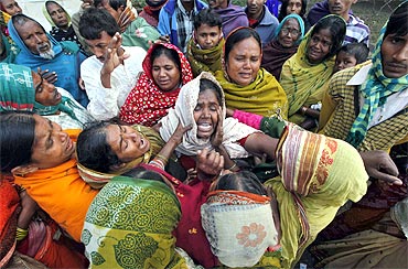 Family members mourn for their relatives outside a hospital at Diamond Harbour