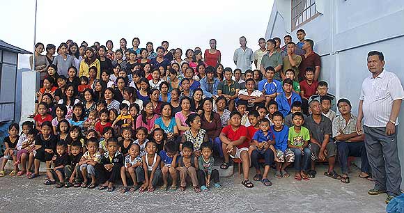 Family members of Ziona (right) pose for group photograph outside their residence in Baktawng village, Mizoram
