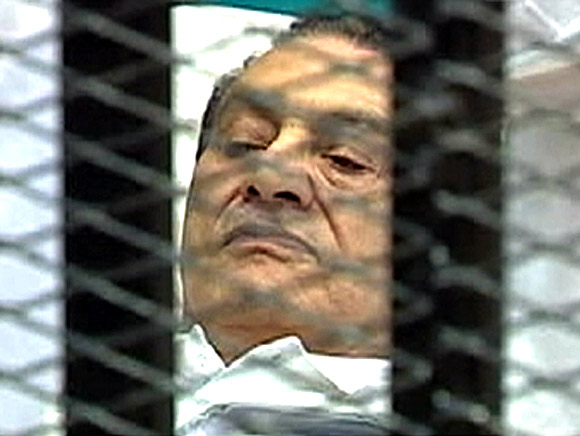 Former Egyptian president Hosni Mubarak is seen in the courtroom for his trial in Cairo