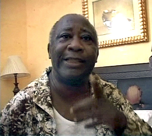 Ivory Coast's Laurent Gbagbo gestures in a room of Hotel Golf in Abidjan after being arrested