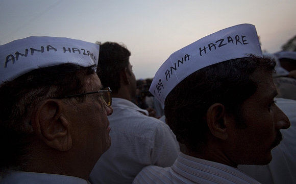Demonstrators wearing caps similar to the one worn by social activist Anna Hazare gather during protest rally against corruption in Mumbai