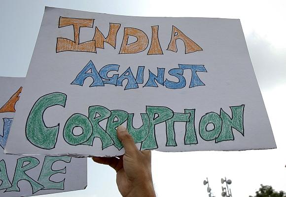 Supporters of veteran Indian social activist Anna Hazare wave placards during a protest rally against corruption in Mumbai