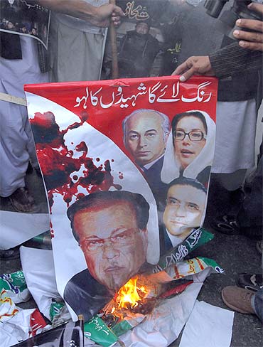 Protesters burn an image of slain Punjab Governor Salam Taseer in Lahore in support of his killer