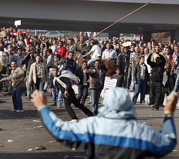 Pro and anti-Mubarak supporters clash during rioting at Tahrir Square