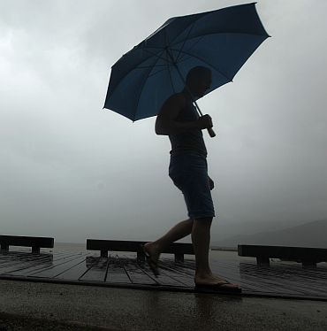 A sightseer walks along the waterfront in the northern Australian city of Cairns