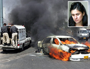 Angry protestors set a car on fire in Karachi (Inset) Kamila Shamsie