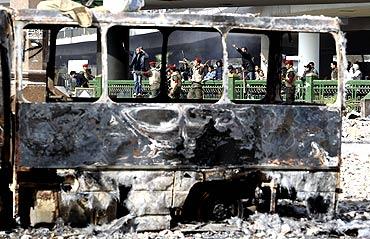 Police try to calm pro-Mubarak supporters shouting at opposition demonstrators in Tahrir Square