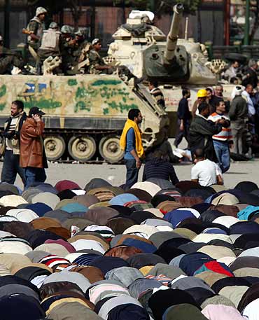 Opposition supporters take part in Friday prayers in Tahrir Square in Cairo