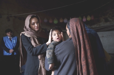 Angelina Jolie meets Khanum Gul, a mother of eight and her youngest son, Samir at their makeshift home at Tamil Mill Bus site in Kabul