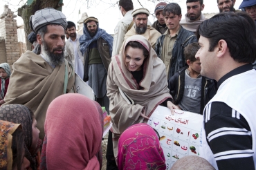 UNHCR Goodwill Ambassador Angelina Jolie presents education material to a local head teacher in a village outside Kabul