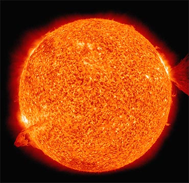 This image of the sun, captured by The Solar Dynamics Observatory spacecraft, shows nearly simultaneous solar eruptions on opposite sides of the Sun