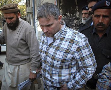 US consulate employee Raymond Davis is escorted by police and officials out of court after facing a judge in Lahore