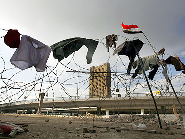 Anti-government protesters' clothes on the barbed wire at the front line of their stronghold in Tahrir square in Cairo