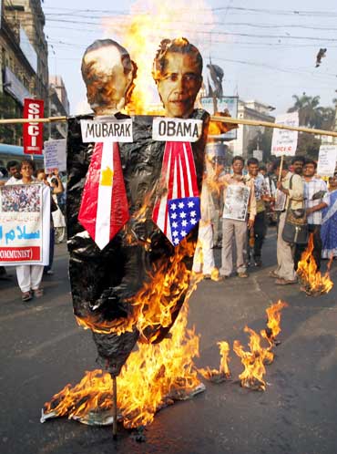 Activists from the Socialist Unity Centre of Indiaburn an effigy depicting Mubarak and Obama during a solidarity rally in Kolkata