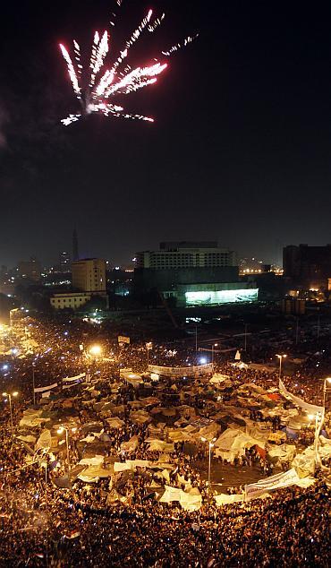 Thousands of Egyptian anti-government protesters celebrate inside Tahrir Square after the announcement of Egyptian President Hosni Mubarak's resignation in Cairo