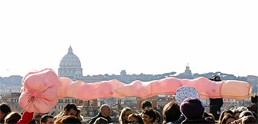 Women hold a balloon during a demonstration against Berlusconi in downtown Rome