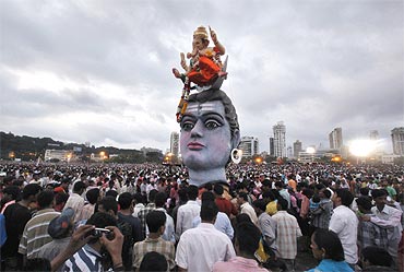 Devotees gather during the immersion of idols of Lord Ganesh in Mumbai