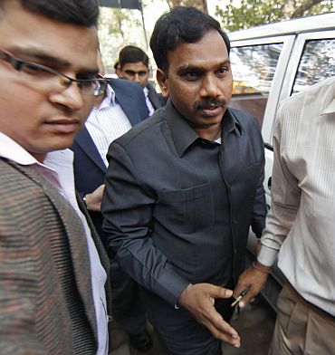 Raja (C) arrives at a court for a hearing in New Delhi on February 17