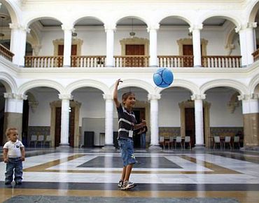 Refugee boys play at the courtyard of the Foreign Ministry headquarters in Caracas
