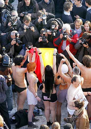 Belgians take part in a mass striptease.