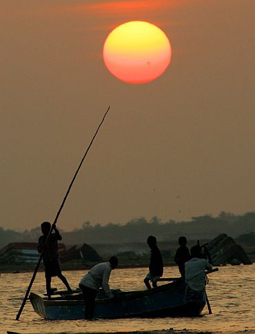 Fishermen row a boat at sunset in Nagaipattinam, Tamil Nadu