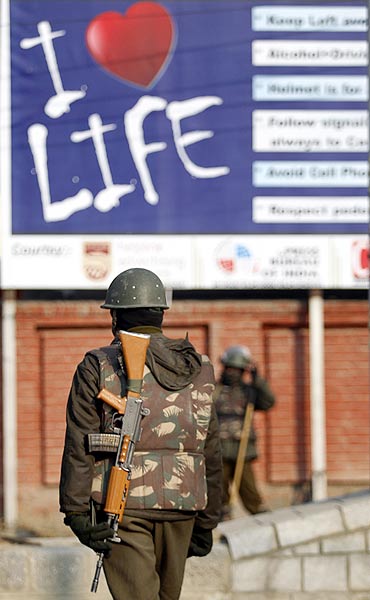 Policemen stand guard at a barricade at Lal Chowk, Srinagar