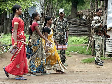 Paramilitary personnel stand guard in Awapalli, Chhattisgarh