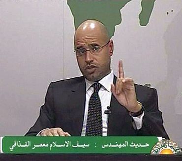 Saif al-Islam, son of Libyan leader Muammar Gaddafi, gestures as he speaks during an address on state television in Tripoli, in this still image taken from video