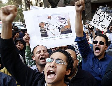 Egyptian and Libyan protesters shout slogans against Libyan leader Muammar Gaddafi