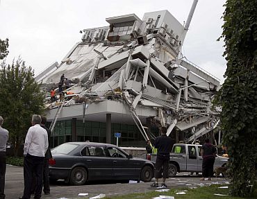 Rescue crews look for staff in the damaged Pyne Gould Guinness building in central Christchurch after the earthquake
