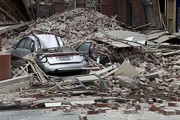 Cars are crushed by fallen concrete after an earthquake in central Christchurch